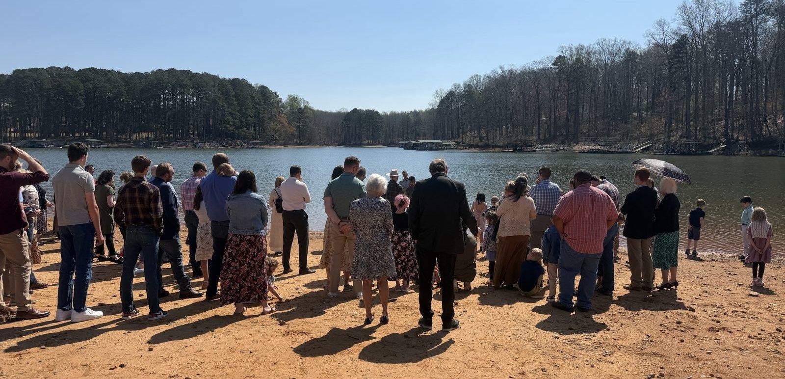 The congregation gathered on the lakeshore for a baptism