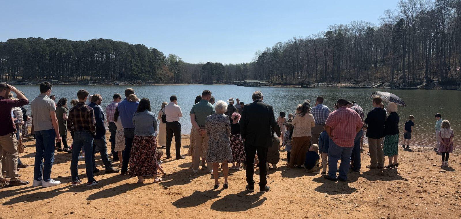 The congregation gathered on the lakeshore for a baptism