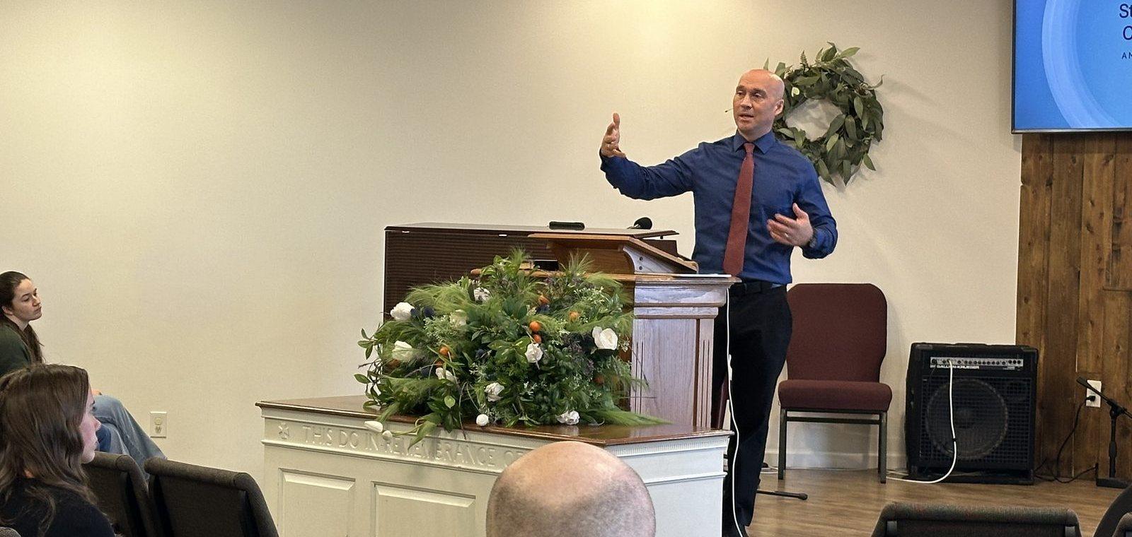 A speaker preaching from the pulpit during the missions conference