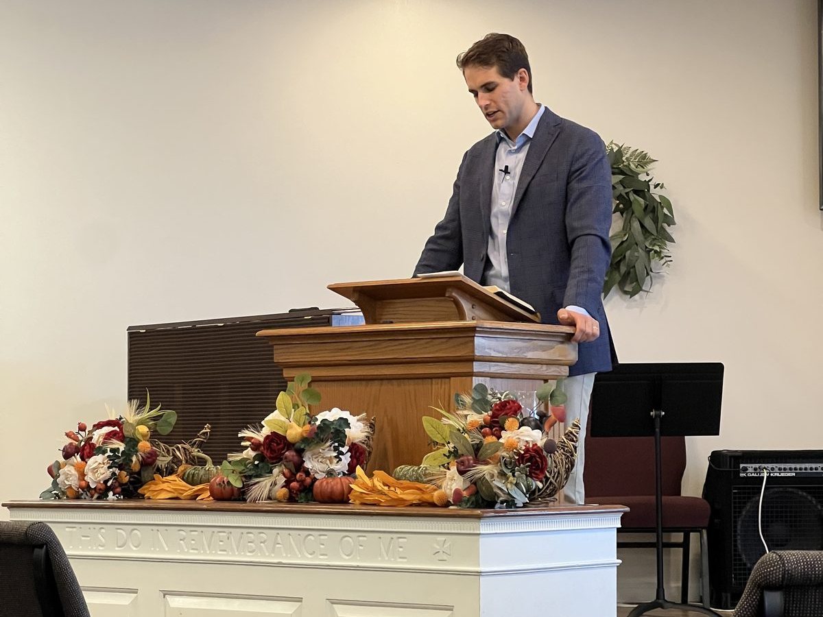 A preacher speaking from the pulpit during a service at Grace Community Church