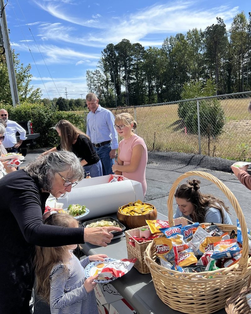 Church members serving food to one another at a fellowship meal